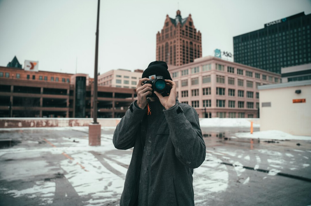 Portrait of a Latin American man with a camera around his neck