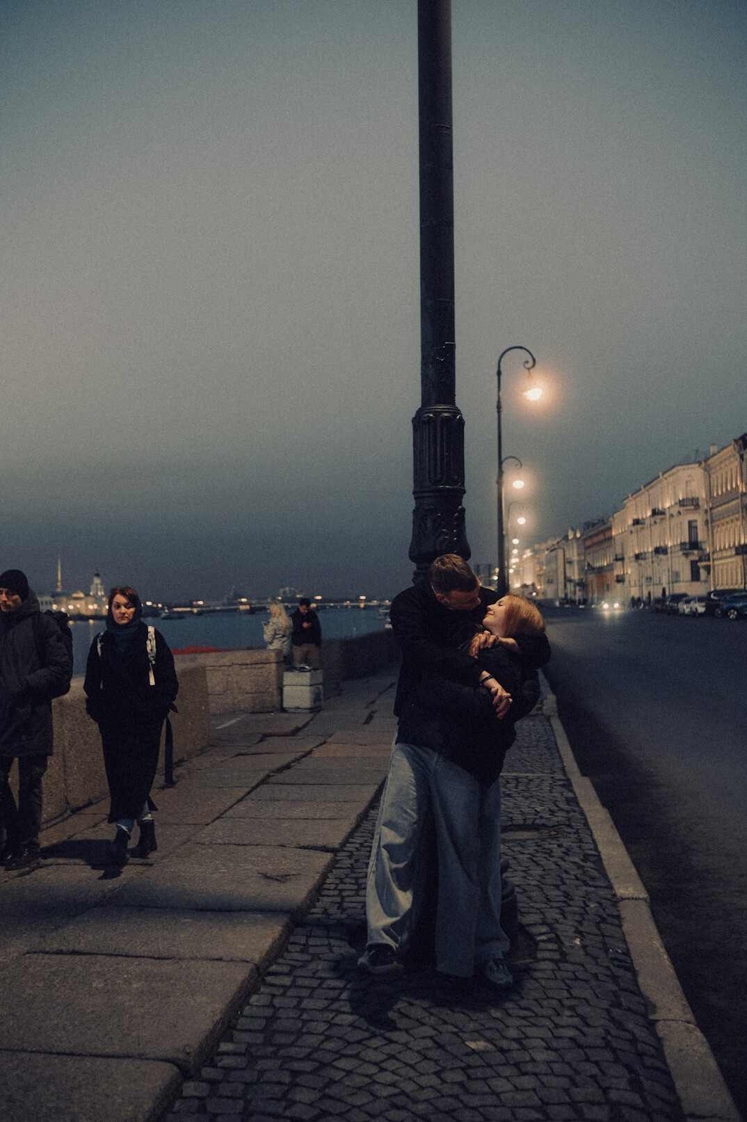 people hugging on street